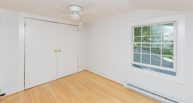 42 Harmony Rd, Pawling, NY 12564 - unfurnished bedroom with a baseboard radiator, wood finished floors, a closet, lofted ceiling, and a ceiling fan