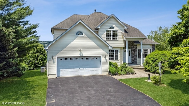 195 Old Castle Point Rd, Wappingers Falls, NY 12590 - traditional-style home featuring asphalt driveway, cooling unit, a front yard, and a shingled roof