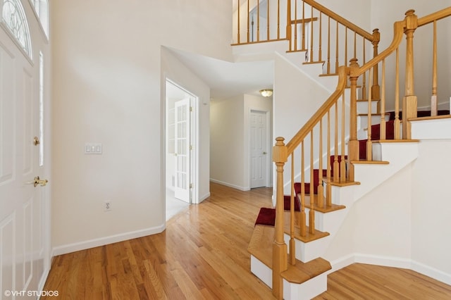 195 Old Castle Point Rd, Wappingers Falls, NY 12590 - foyer featuring wood finished floors, a high ceiling, stairs, and baseboards