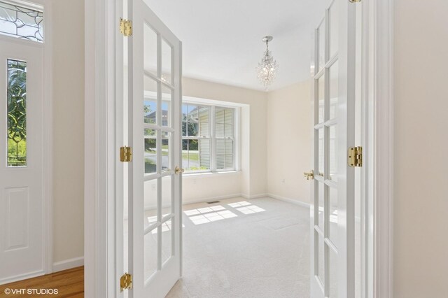 195 Old Castle Point Rd, Wappingers Falls, NY 12590 - doorway to outside with french doors, a chandelier, plenty of natural light, and baseboards