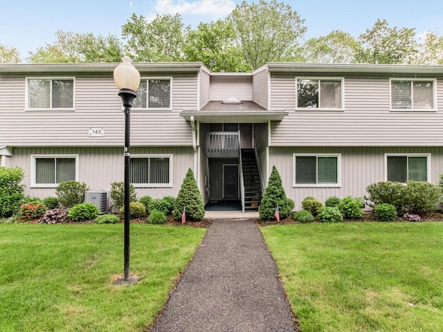 143 Flintlock Way Unit D, Yorktown Heights, NY 10598 - view of front of house with stairs, a front yard, and cooling unit