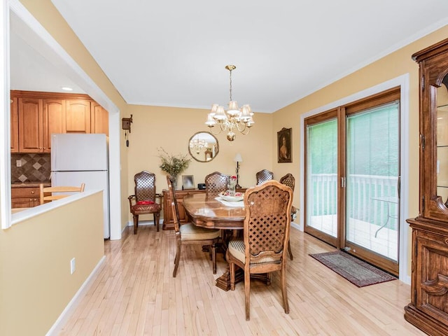 143 Flintlock Way Unit D, Yorktown Heights, NY 10598 - dining area with light wood-style flooring, a chandelier, ornamental molding, and baseboards
