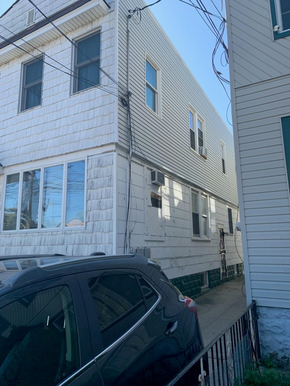 1528 Remsen Ave, Brooklyn, NY 11236 - view of side of property with an AC wall unit