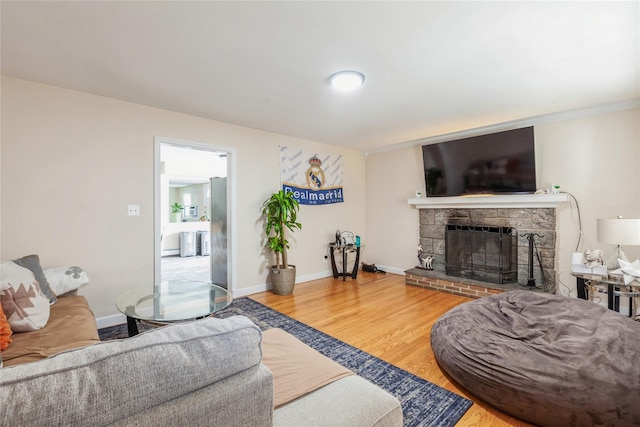 55 Nassau Ave, Glen Cove, NY 11542 - living room with a fireplace, wood finished floors, and baseboards