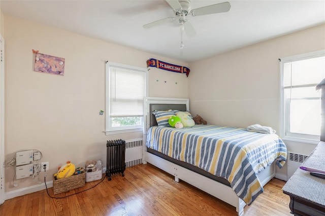 55 Nassau Ave, Glen Cove, NY 11542 - bedroom with radiator, wood finished floors, and baseboards