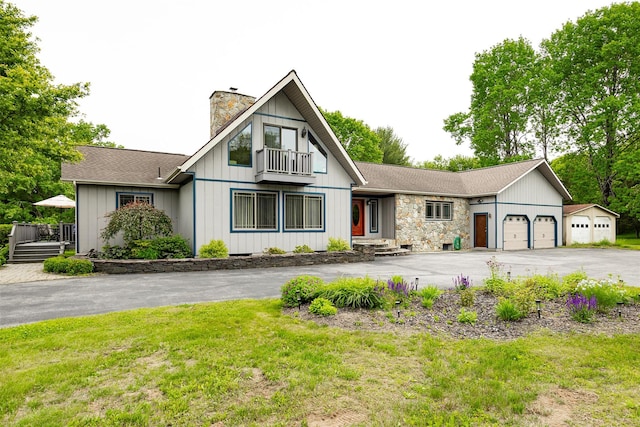 129 Clinton Corners Rd, Salt Point, NY 12578 - view of front of home featuring asphalt driveway, an attached garage, a chimney, a balcony, and a front yard