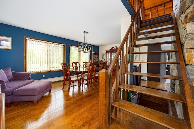 129 Clinton Corners Rd, Salt Point, NY 12578 - dining space with wood finished floors, stairway, and a chandelier