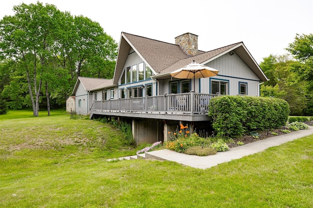 129 Clinton Corners Rd, Salt Point, NY 12578 - rear view of house with a wooden deck, a chimney, a lawn, and a shingled roof