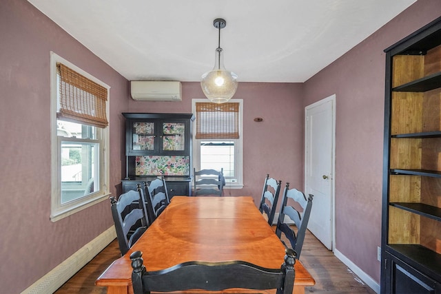 10 June Ave, Bayville, NY 11709 - dining area with a wall mounted air conditioner, dark wood-style floors, baseboards, and baseboard heating