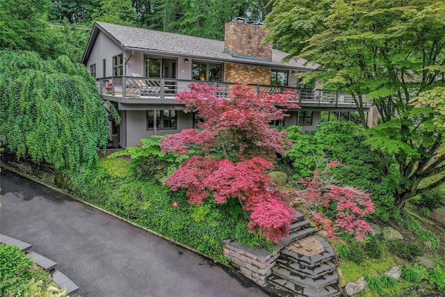 6 Laurel Way, Sea Cliff, NY 11579 - view of front facade with a chimney and a balcony