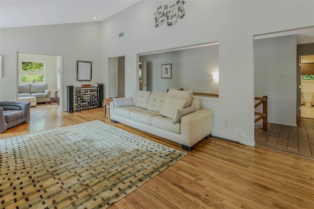 6 Laurel Way, Sea Cliff, NY 11579 - living room with high vaulted ceiling, light wood finished floors, baseboard heating, and baseboards