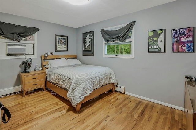 6 Laurel Way, Sea Cliff, NY 11579 - bedroom with light wood finished floors, baseboards, a baseboard heating unit, and cooling unit