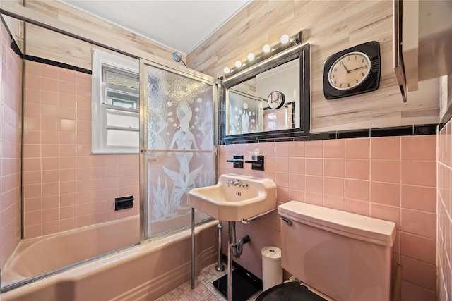150-44 23rd Ave, Whitestone, NY 11357 - bathroom featuring shower / bath combination with glass door, toilet, a sink, tile walls, and tile patterned floors
