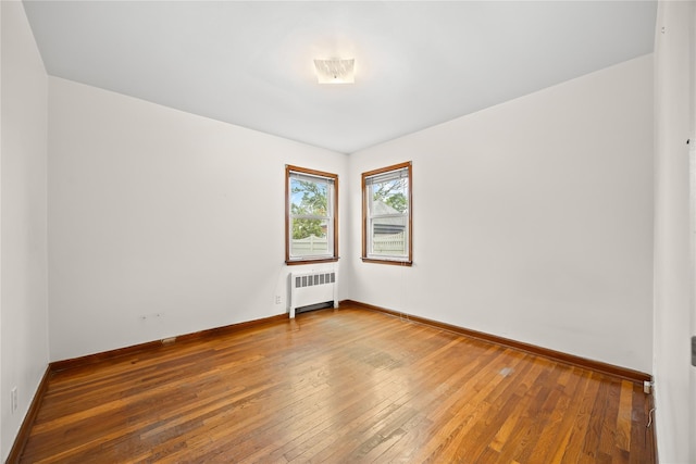 150-44 23rd Ave, Whitestone, NY 11357 - unfurnished room featuring radiator, hardwood / wood-style flooring, and baseboards