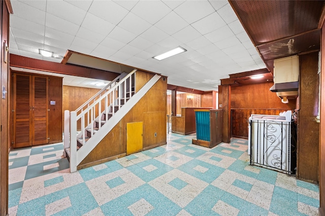 150-44 23rd Ave, Whitestone, NY 11357 - finished below grade area with wood walls, a bar, stairs, and tile patterned floors