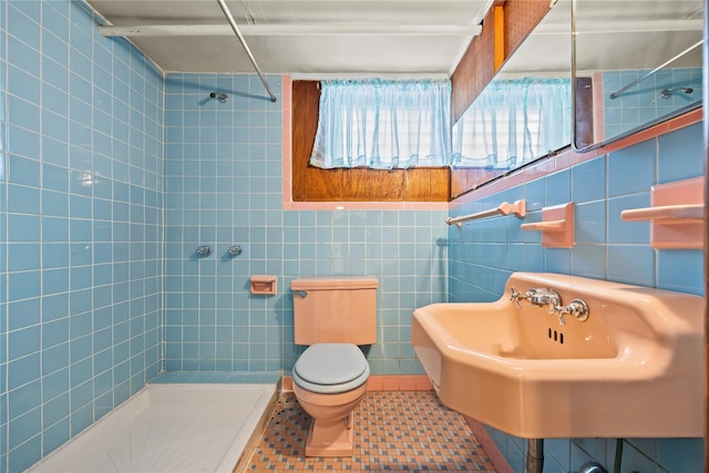 150-44 23rd Ave, Whitestone, NY 11357 - bathroom featuring tiled shower, toilet, tile walls, tile patterned flooring, and a sink