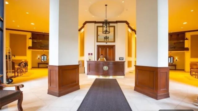 ONE Bay Club Dr Unit 18S, Bayside, NY 11360 - welcome area featuring a high ceiling, a decorative wall, and wainscoting