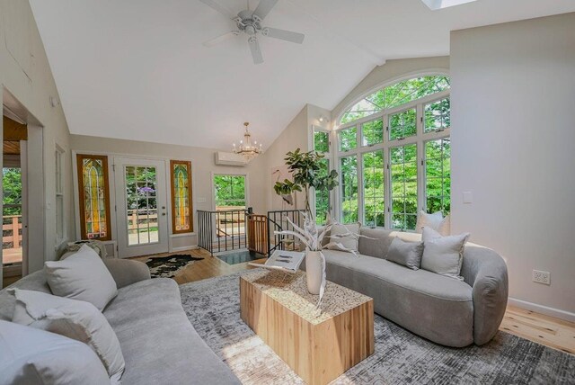 10 Maple Ave, Setauket, NY 11733 - living area with high vaulted ceiling, light wood-style floors, plenty of natural light, baseboards, and a chandelier