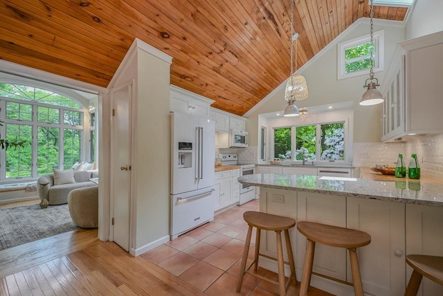 10 Maple Ave, Setauket, NY 11733 - kitchen featuring white appliances, a peninsula, white cabinets, wooden ceiling, and pendant lighting