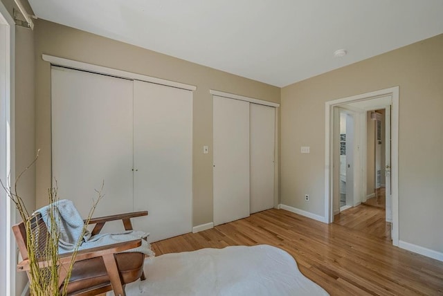 10 Maple Ave, Setauket, NY 11733 - bedroom with multiple closets, wood finished floors, and baseboards