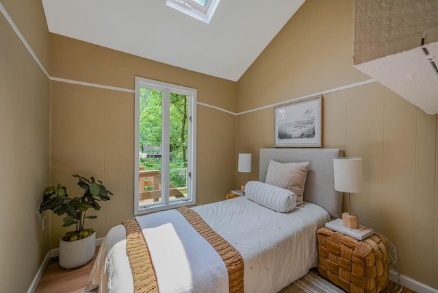 10 Maple Ave, Setauket, NY 11733 - bedroom with a skylight, lofted ceiling, wood finished floors, and baseboards