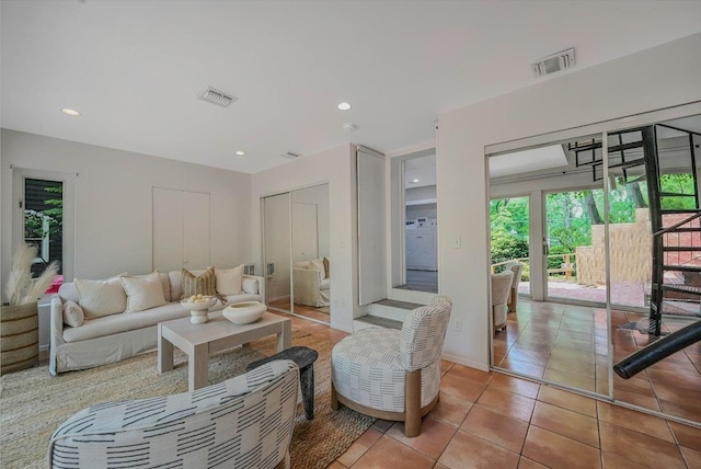 10 Maple Ave, Setauket, NY 11733 - living room featuring light tile patterned flooring, washer / clothes dryer, and recessed lighting