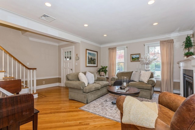 12 5th Pl, Garden City, NY 11530 - living room featuring light wood-style flooring, stairway, ornamental molding, recessed lighting, and baseboards