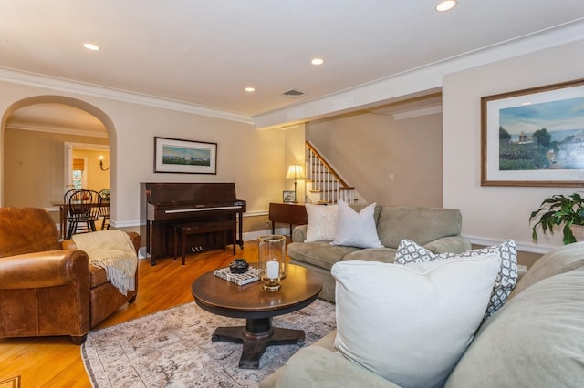 12 5th Pl, Garden City, NY 11530 - living room with arched walkways, light wood finished floors, crown molding, stairway, and recessed lighting