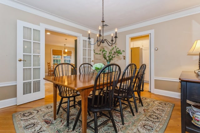 12 5th Pl, Garden City, NY 11530 - dining room featuring a chandelier, wood finished floors, ornamental molding, and baseboards