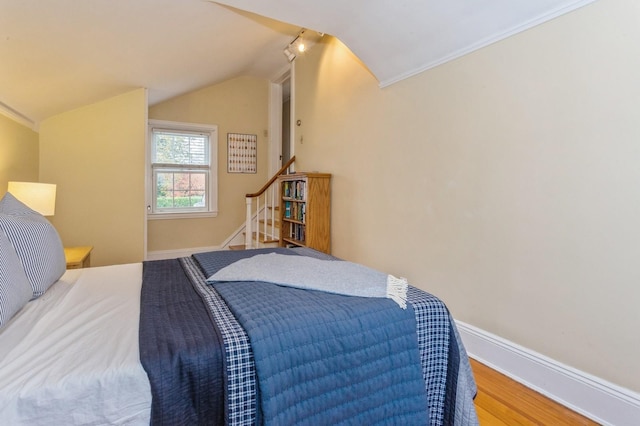 12 5th Pl, Garden City, NY 11530 - bedroom with lofted ceiling, wood finished floors, baseboards, and crown molding