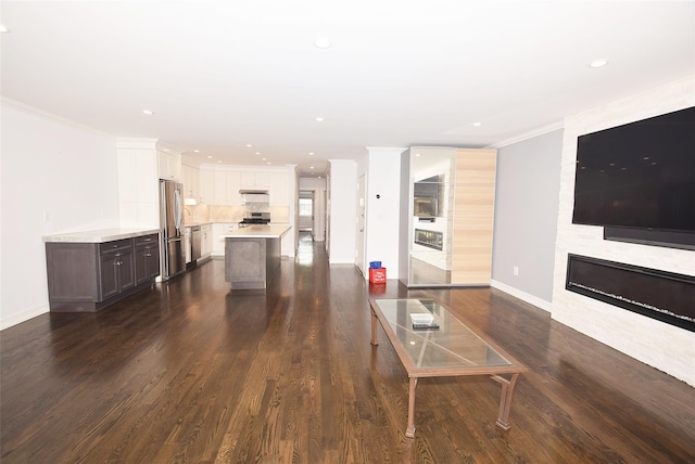 206-07 Lori Dr Unit 60M, Bayside, NY 11360 - living room featuring ornamental molding, dark wood-style flooring, a fireplace, baseboards, and recessed lighting
