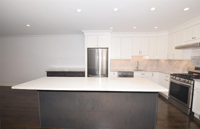 206-07 Lori Dr Unit 60M, Bayside, NY 11360 - kitchen with appliances with stainless steel finishes, a sink, under cabinet range hood, white cabinets, and crown molding
