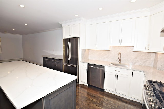 206-07 Lori Dr Unit 60M, Bayside, NY 11360 - kitchen with appliances with stainless steel finishes, a sink, light stone counters, backsplash, and white cabinetry