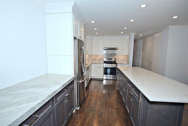 206-07 Lori Dr Unit 60M, Bayside, NY 11360 - kitchen with stainless steel appliances, dark wood-style floors, white cabinets, under cabinet range hood, and a kitchen island