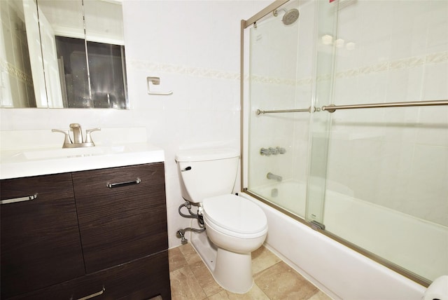 206-07 Lori Dr Unit 60M, Bayside, NY 11360 - full bathroom featuring vanity, toilet, bath / shower combo with glass door, and tile walls