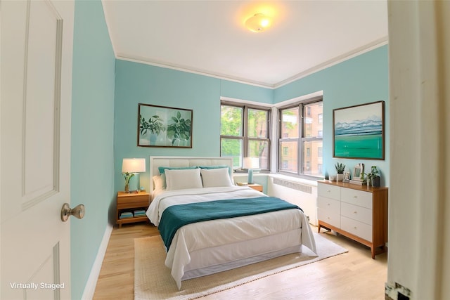 190 E Mosholu Pkwy S Unit 3H, Bronx, NY 10458 - bedroom with radiator heating unit, ornamental molding, light wood-style floors, and baseboards