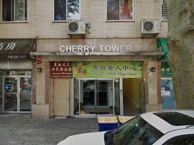 134-40 Cherry Ave Unit 4F, Flushing, NY 11355 - view of exterior entry with brick siding and ac unit