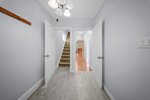 114-23 Sutter Ave, South Ozone Park, NY 11420 - hall featuring light wood-style floors, a chandelier, stairway, baseboards, and recessed lighting