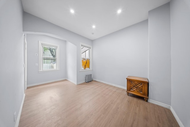 114-23 Sutter Ave, South Ozone Park, NY 11420 - spare room featuring wood finished floors, lofted ceiling, recessed lighting, radiator, and baseboards