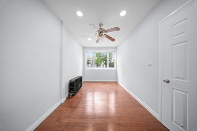 114-23 Sutter Ave, South Ozone Park, NY 11420 - unfurnished living room featuring radiator, a ceiling fan, wood finished floors, baseboards, and recessed lighting