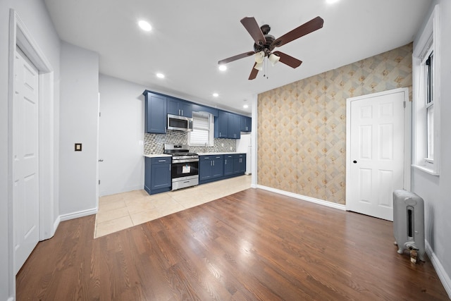 114-23 Sutter Ave, South Ozone Park, NY 11420 - unfurnished living room featuring radiator, baseboards, a ceiling fan, wallpapered walls, and recessed lighting