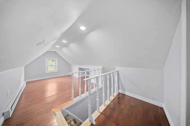 114-23 Sutter Ave, South Ozone Park, NY 11420 - bonus room with a baseboard heating unit, lofted ceiling, wood finished floors, and baseboards