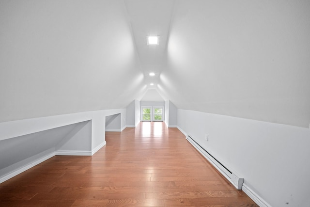 114-23 Sutter Ave, South Ozone Park, NY 11420 - additional living space featuring a baseboard radiator, lofted ceiling, wood finished floors, and baseboards
