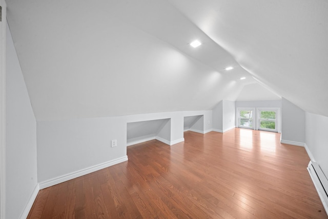 114-23 Sutter Ave, South Ozone Park, NY 11420 - bonus room with baseboard heating, vaulted ceiling, wood finished floors, and baseboards