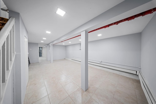 114-23 Sutter Ave, South Ozone Park, NY 11420 - finished basement with a baseboard radiator, recessed lighting, and light tile patterned floors