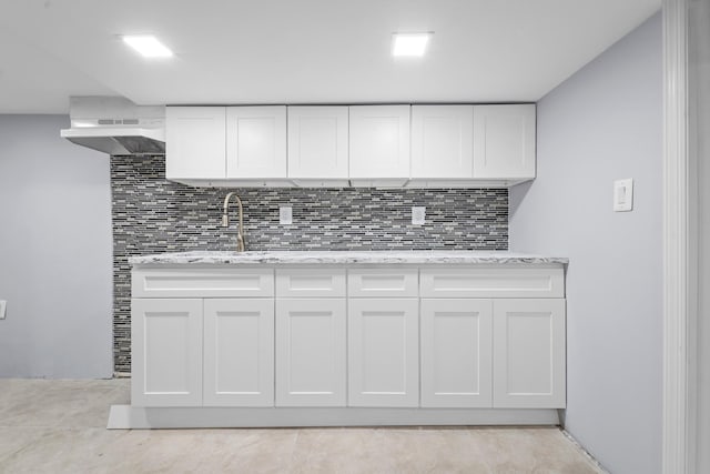 114-23 Sutter Ave, South Ozone Park, NY 11420 - kitchen with backsplash, white cabinets, and light stone counters