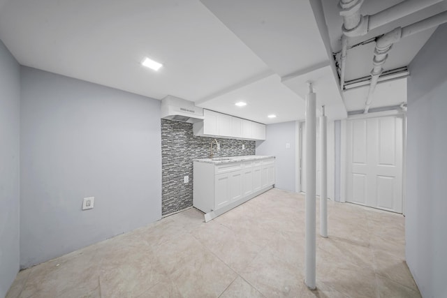 114-23 Sutter Ave, South Ozone Park, NY 11420 - kitchen featuring light countertops, white cabinetry, a sink, recessed lighting, and decorative backsplash
