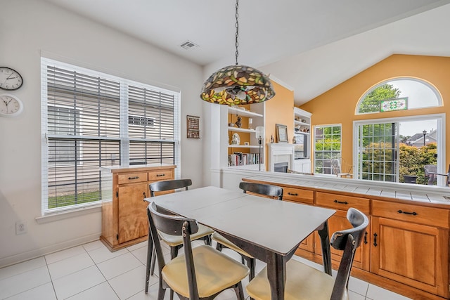 105 Louden Loop, Mount Sinai, NY 11766 - dining room with a fireplace, lofted ceiling, light tile patterned floors, and baseboards