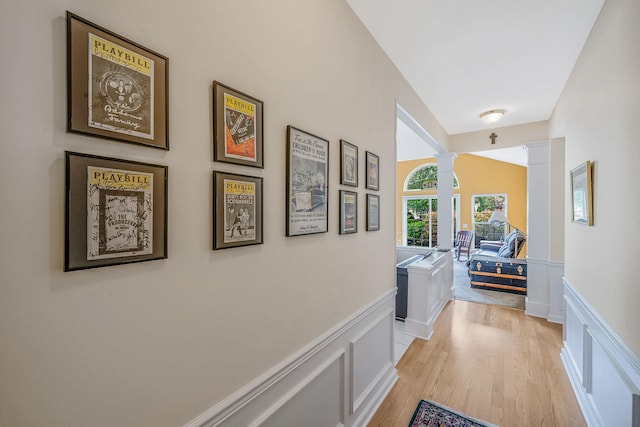 105 Louden Loop, Mount Sinai, NY 11766 - hall with a decorative wall, wainscoting, light wood finished floors, and ornate columns