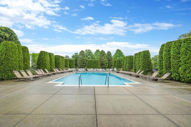 105 Louden Loop, Mount Sinai, NY 11766 - community pool featuring a patio area and a wooded view